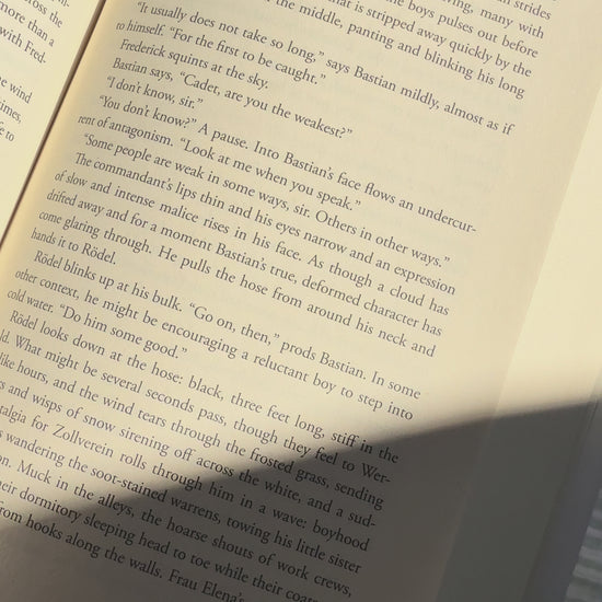 Video showing the handcrafted "In My Safe Place" linen bookmark placed inside an open book, highlighting its double-sided design and linen texture.
